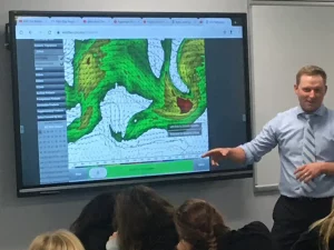 Meteorologist visit featuring a Meteorologist, Ryan Michaels explaining how a weather map works.