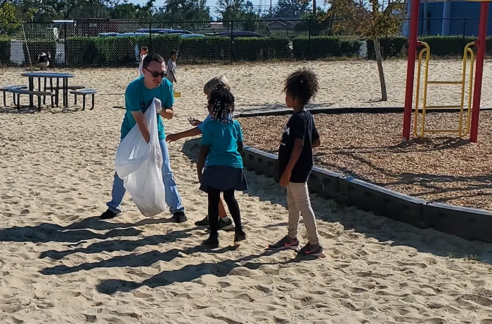 NHS Clean School event, children help clean a park.